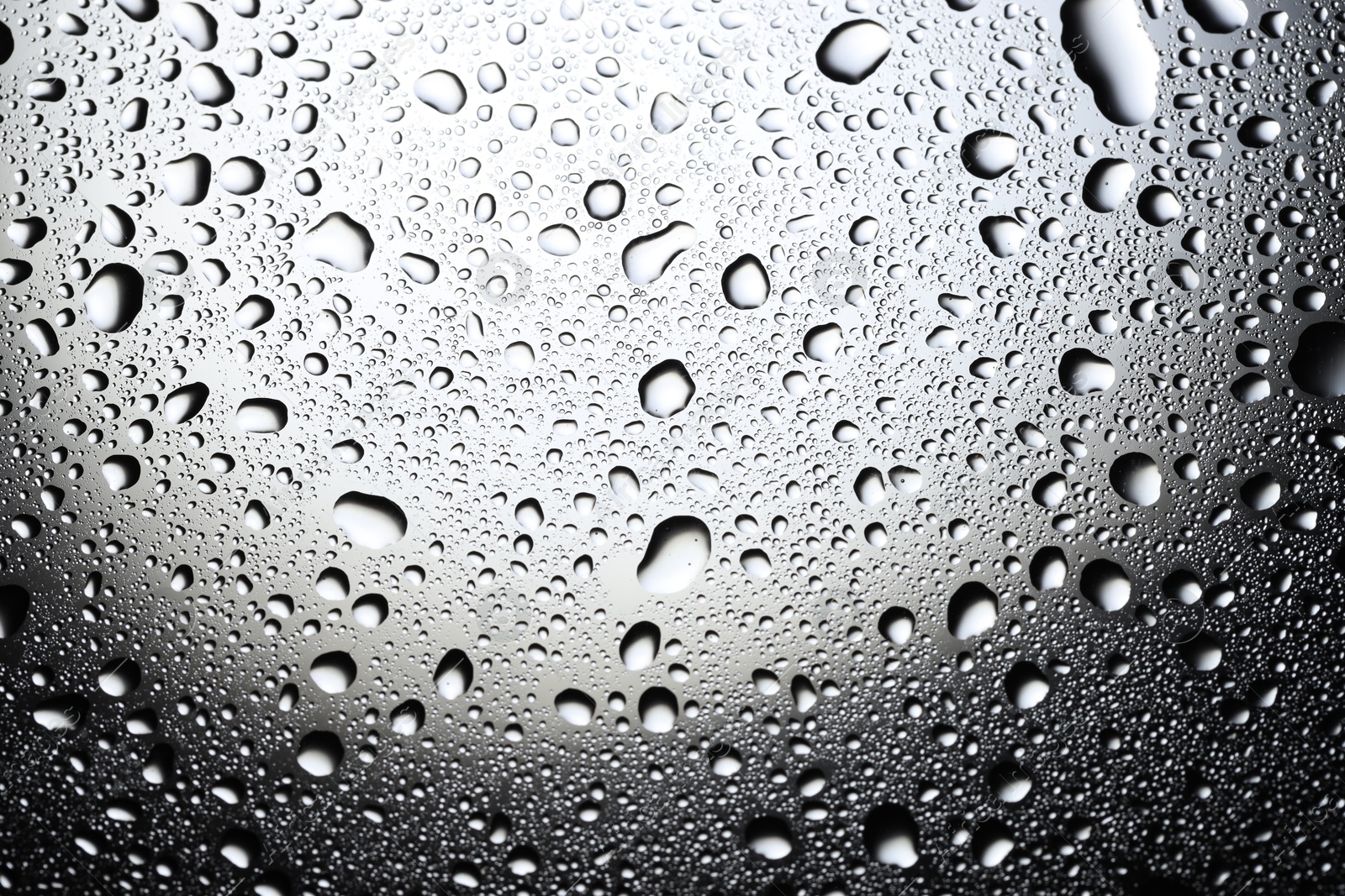 Photo of Water drops on glass surface, top view