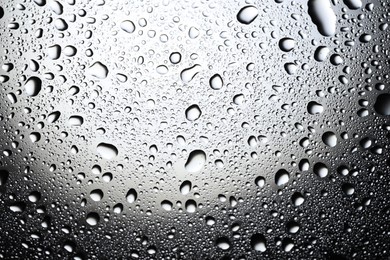 Photo of Water drops on glass surface, top view