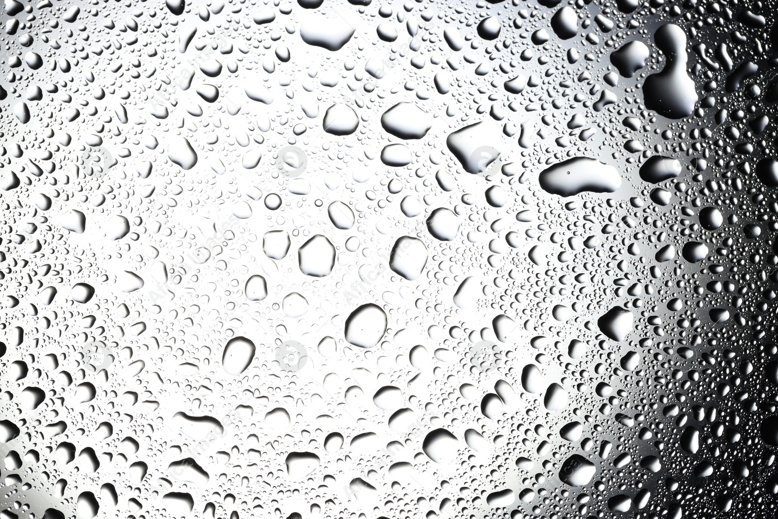 Photo of Water drops on glass surface, top view