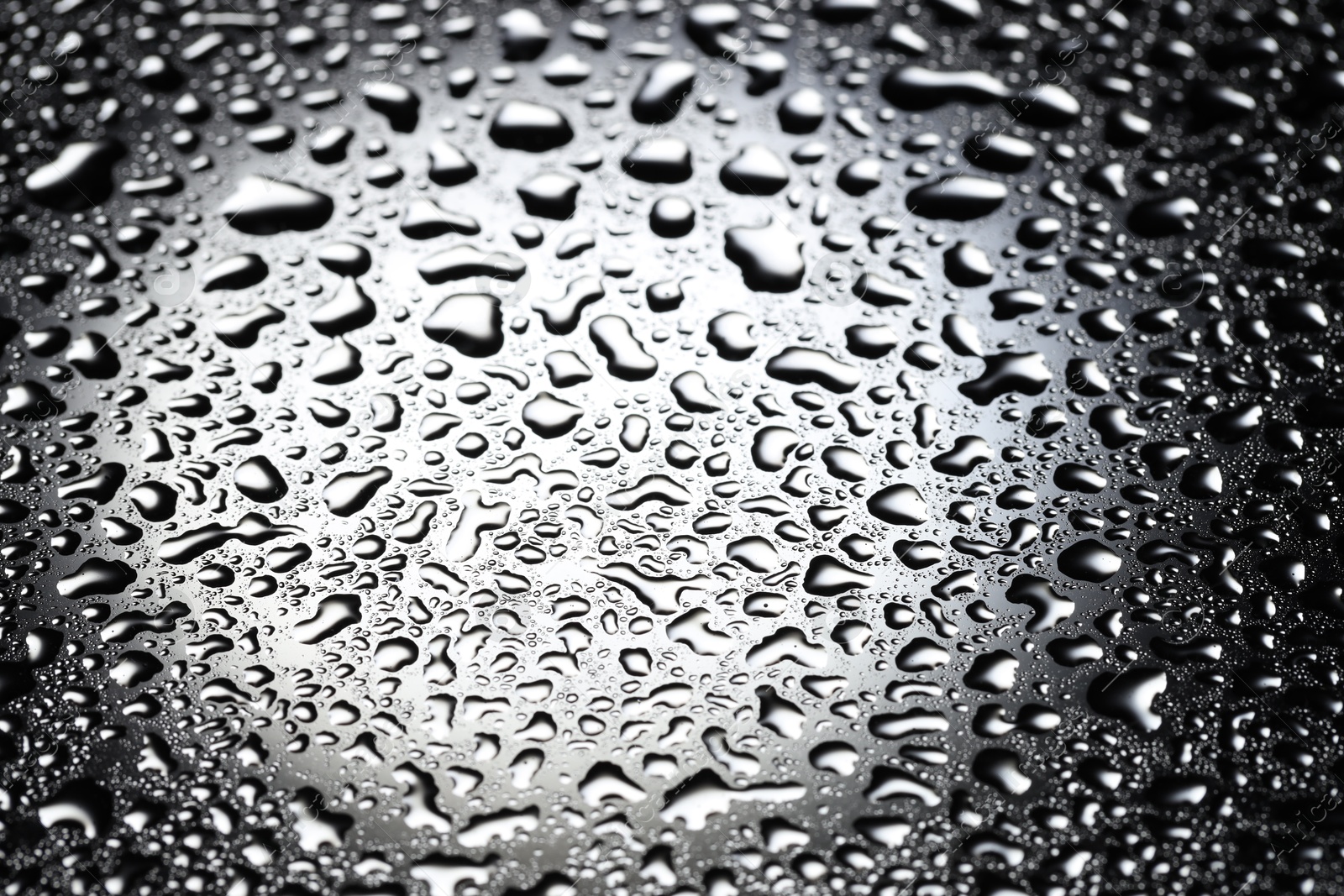 Photo of Water drops on glass surface, top view