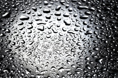 Photo of Water drops on glass surface, top view