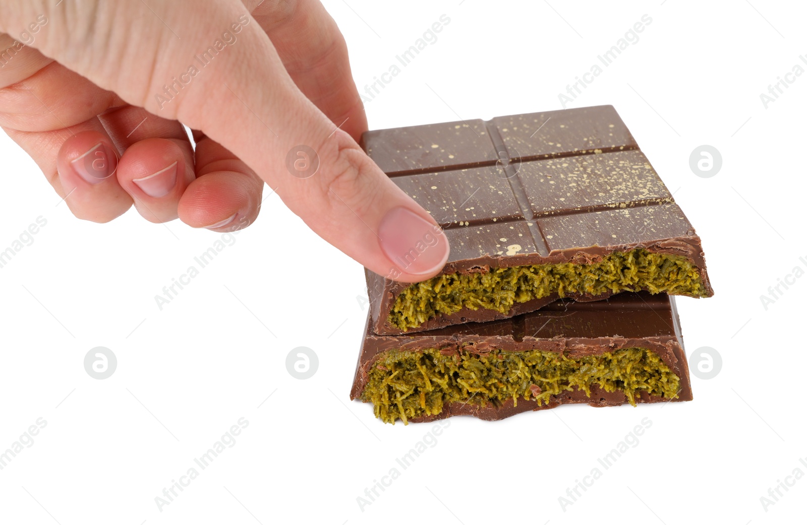 Photo of Woman taking piece of tasty Dubai chocolate with pistachios and knafeh on white background, closeup