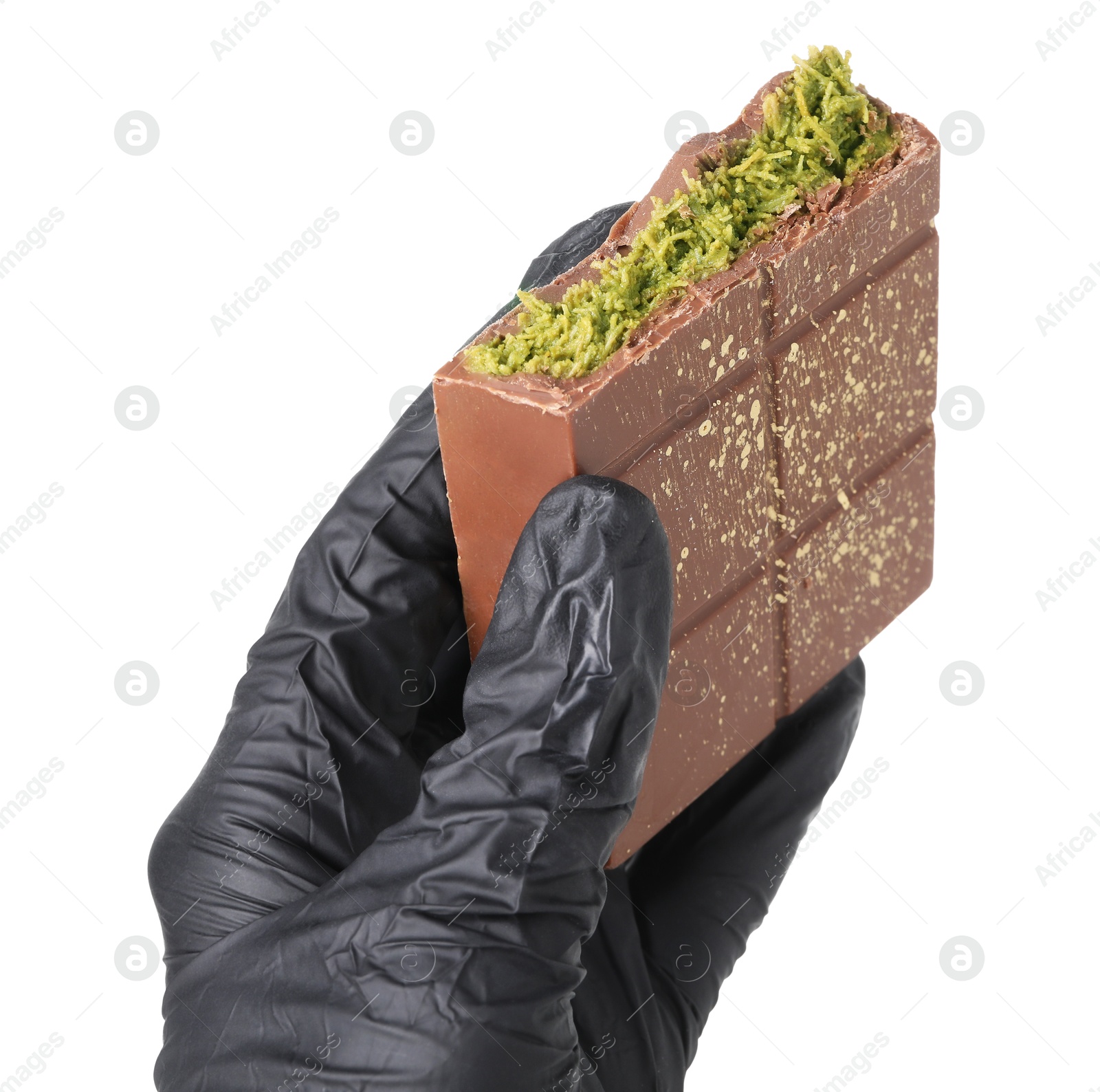 Photo of Woman holding piece of tasty Dubai chocolate bar with pistachios and knafeh on white background, closeup