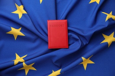 Photo of Passport in red cover on flag of European Union, top view