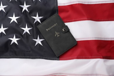 Photo of Passport in black cover on flag of United States, top view