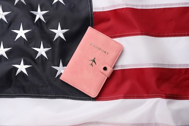 Photo of Passport in pink cover on flag of United States, top view