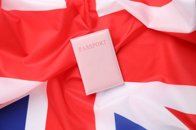 Photo of Passport in pink cover on flag of United Kingdom, top view