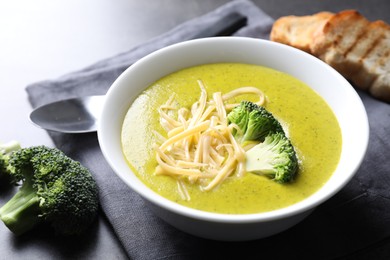 Photo of Delicious broccoli cream soup served on gray table, closeup