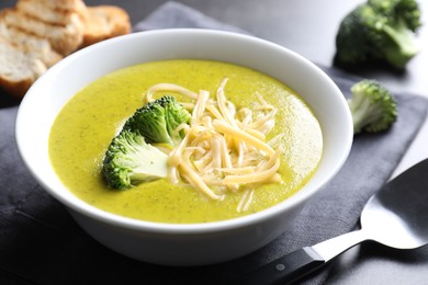 Photo of Delicious broccoli cream soup served on gray table, closeup