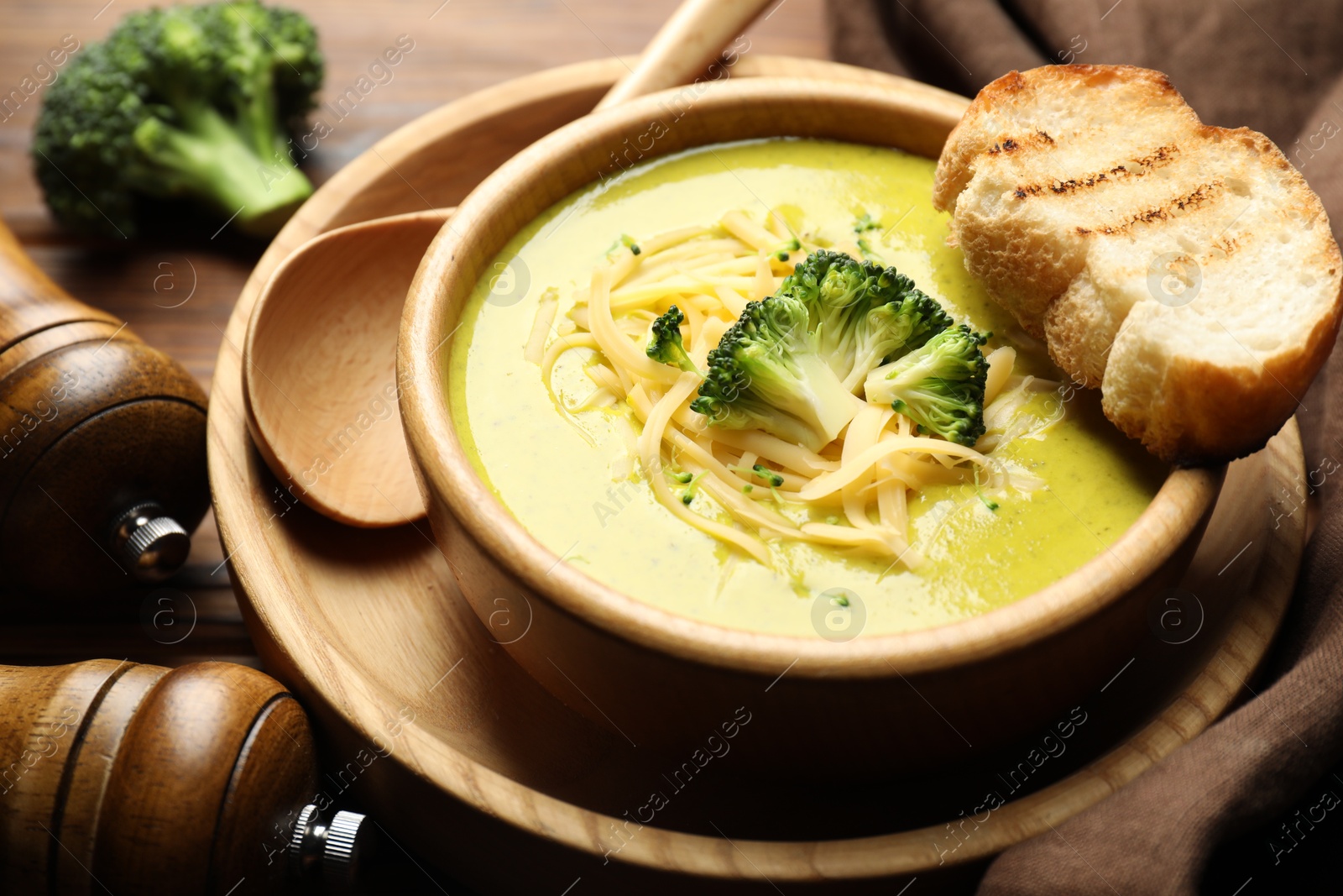 Photo of Delicious broccoli cream soup served on table, closeup