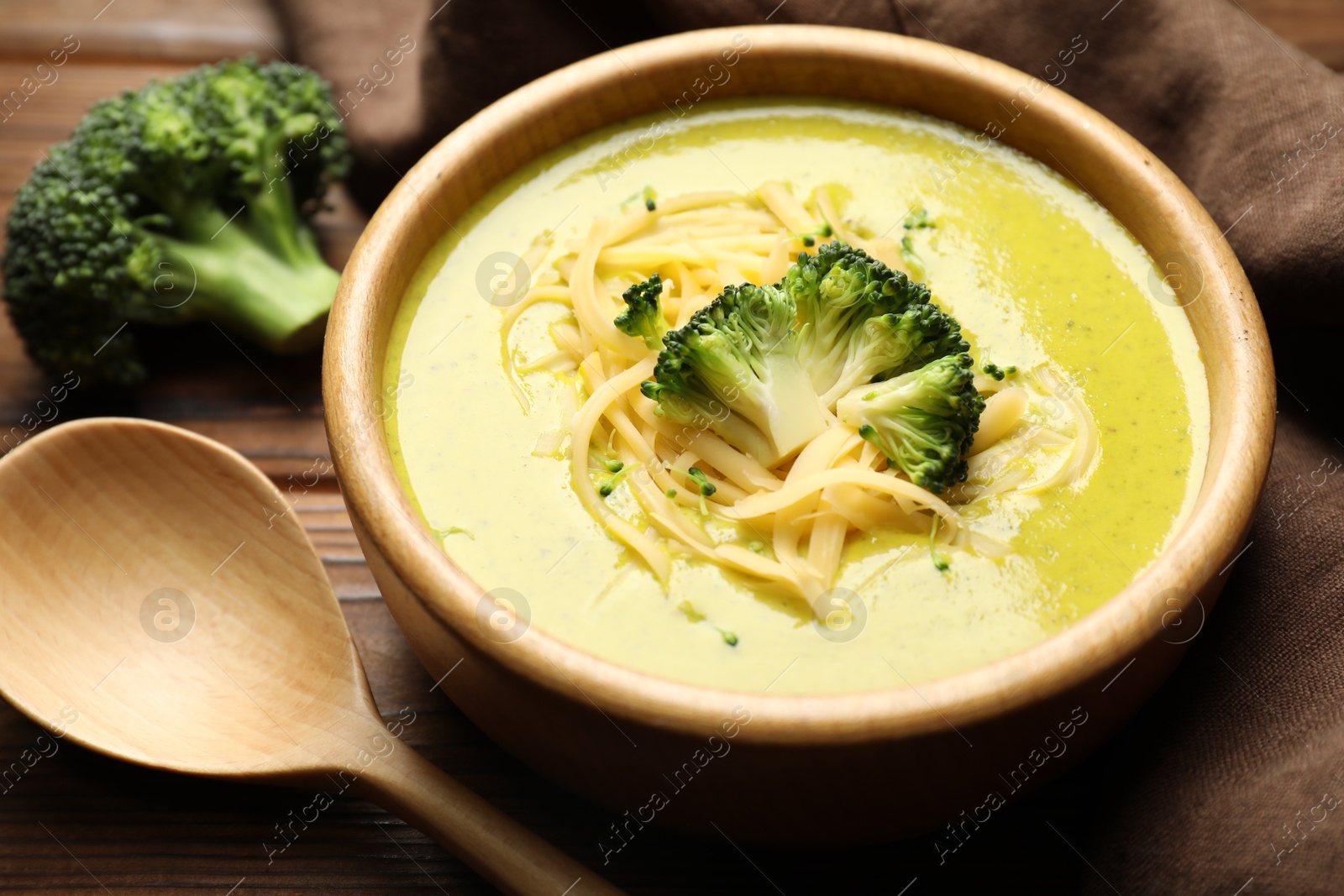 Photo of Delicious broccoli cream soup served on table, closeup