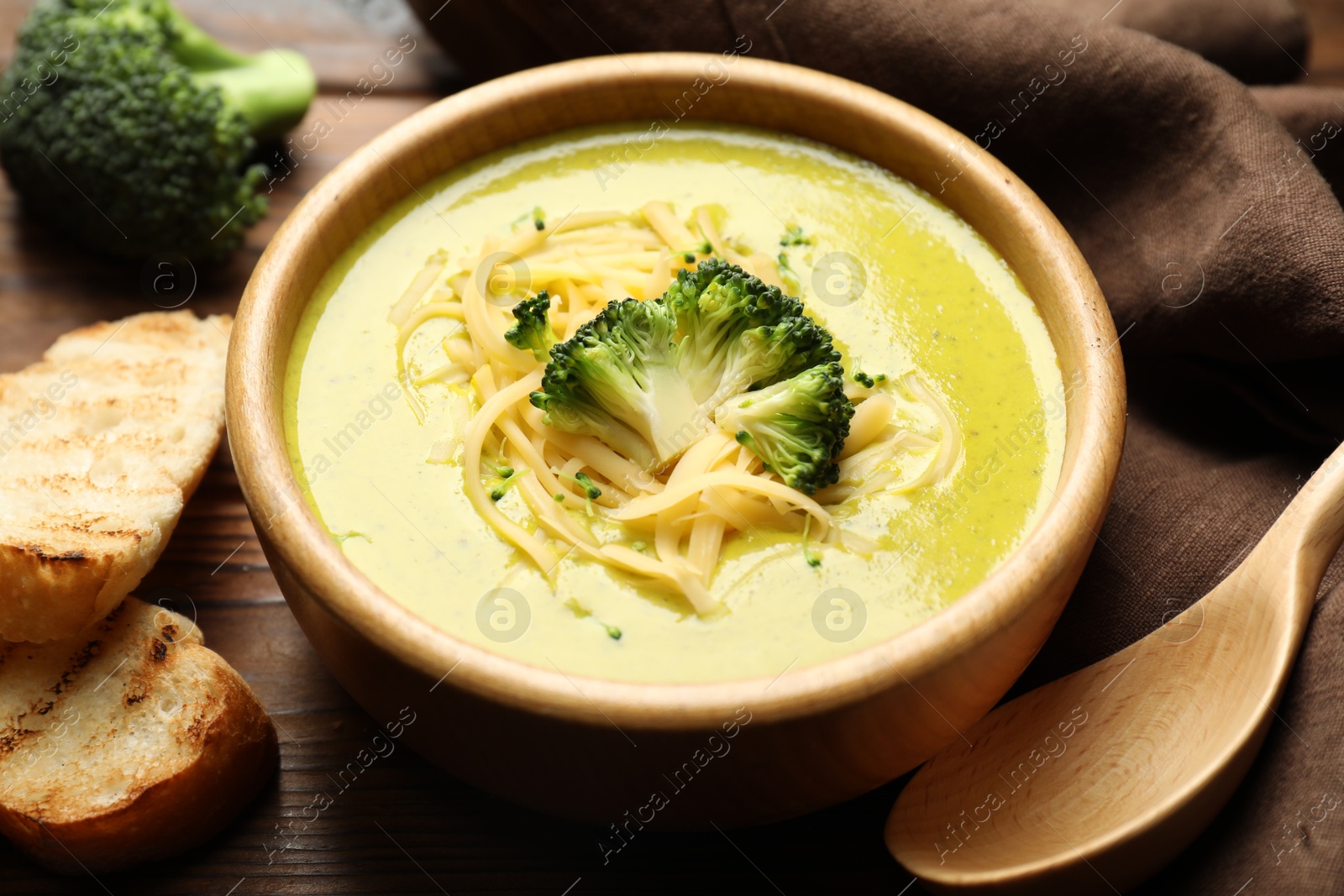 Photo of Delicious broccoli cream soup served on table, closeup