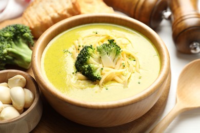 Photo of Delicious broccoli cream soup served on table, closeup