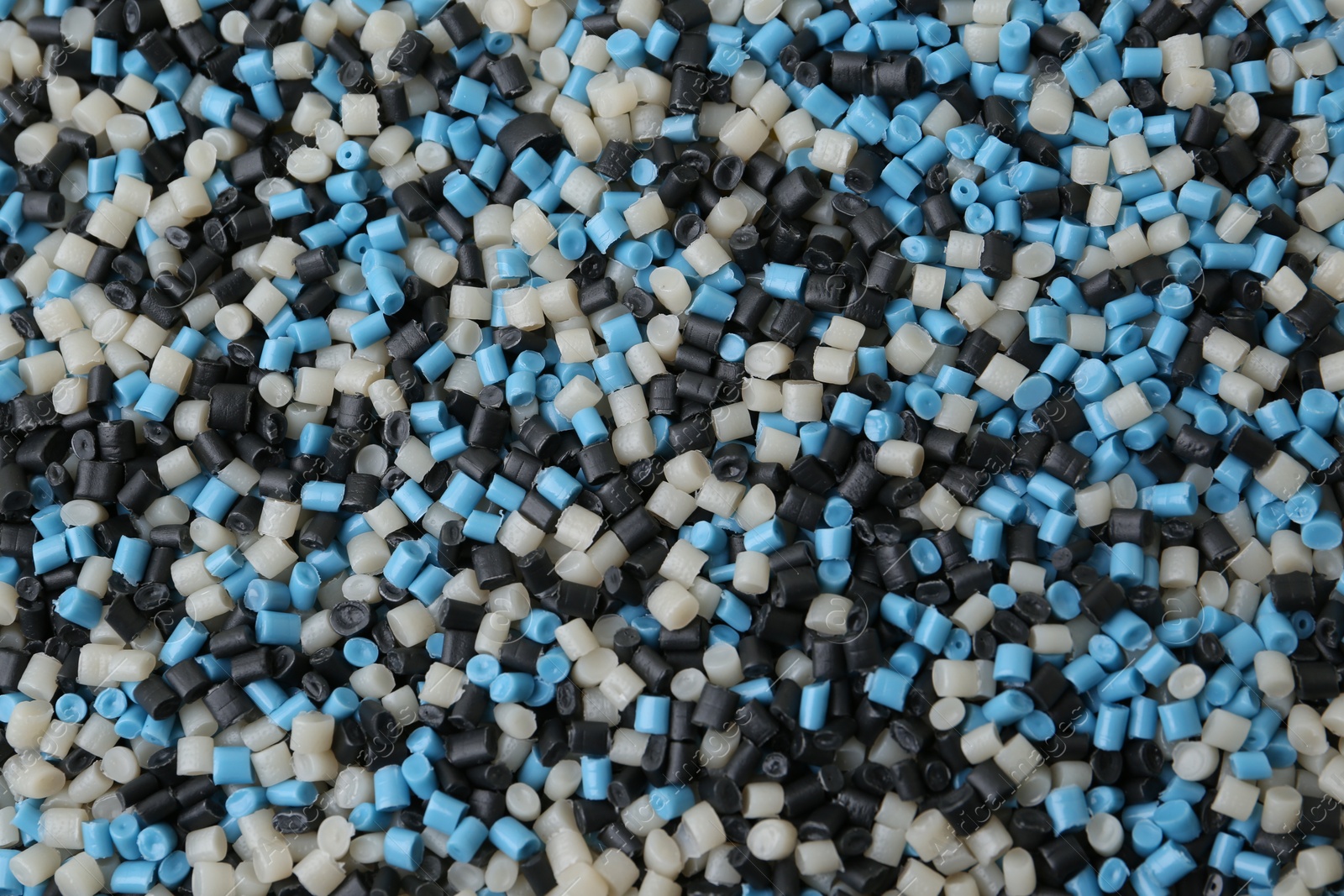 Photo of Pile of colorful plastic granules as background, top view