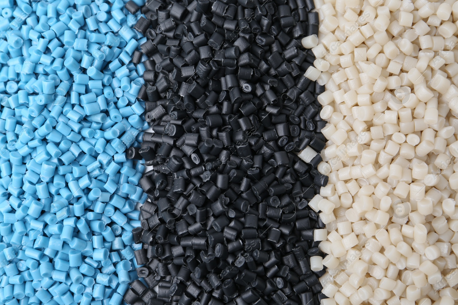 Photo of Pile of colorful plastic granules as background, top view