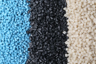 Photo of Pile of colorful plastic granules as background, top view