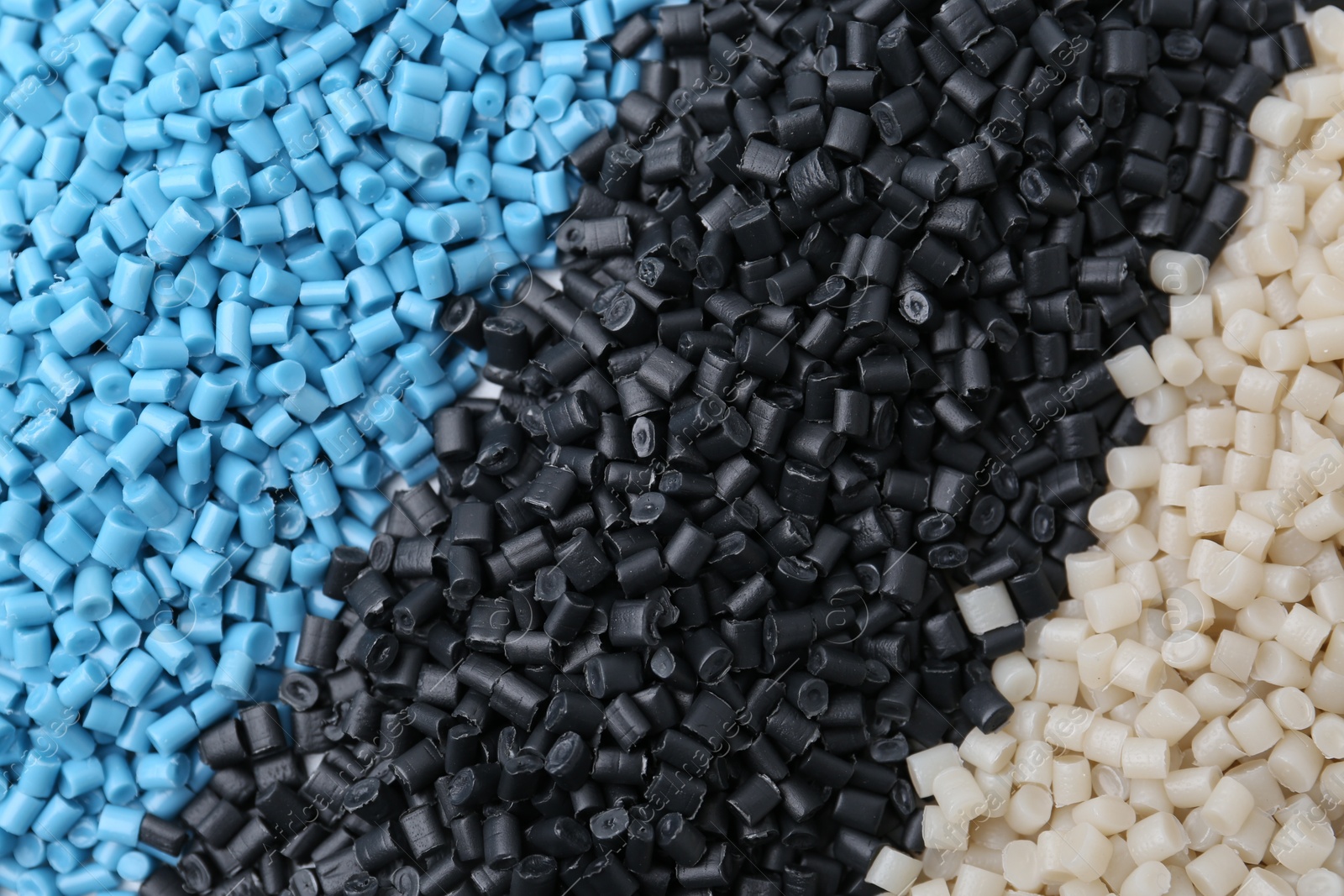 Photo of Pile of colorful plastic granules as background, top view