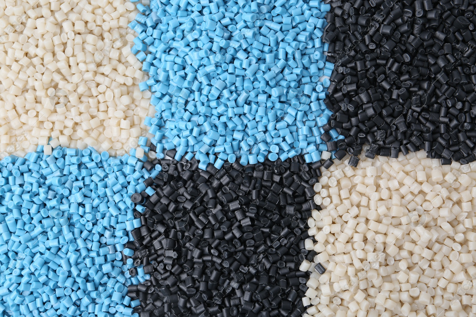 Photo of Pile of colorful plastic granules as background, top view