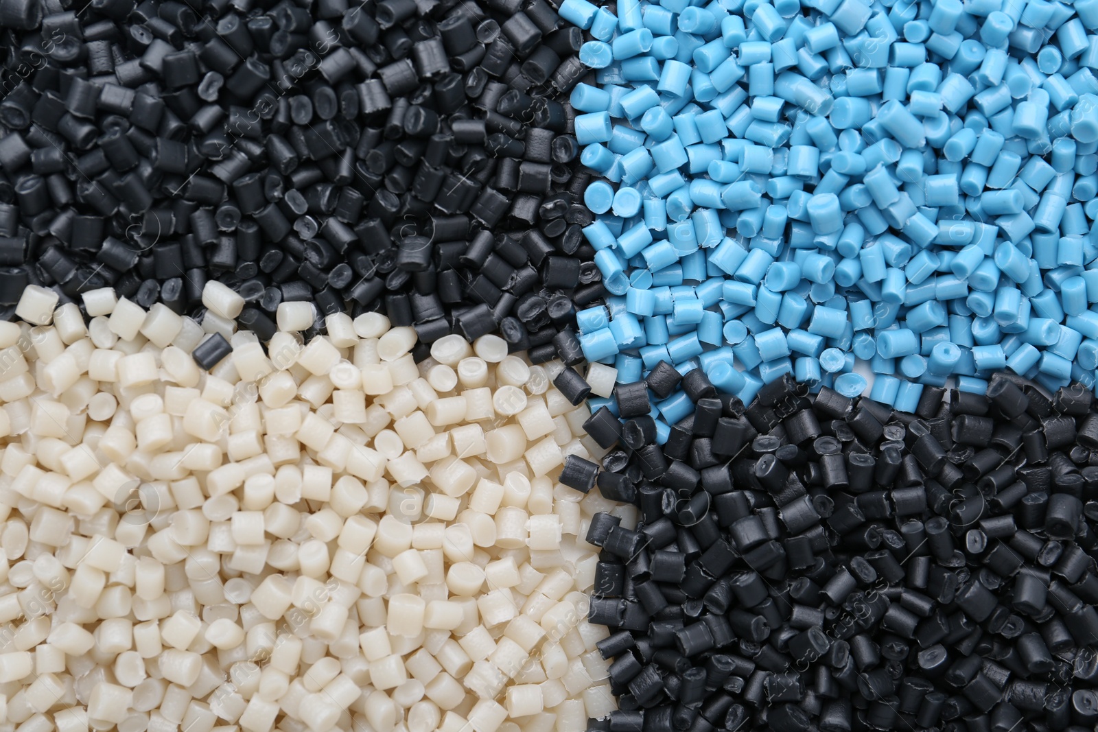 Photo of Pile of colorful plastic granules as background, top view