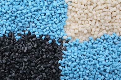 Pile of colorful plastic granules as background, top view