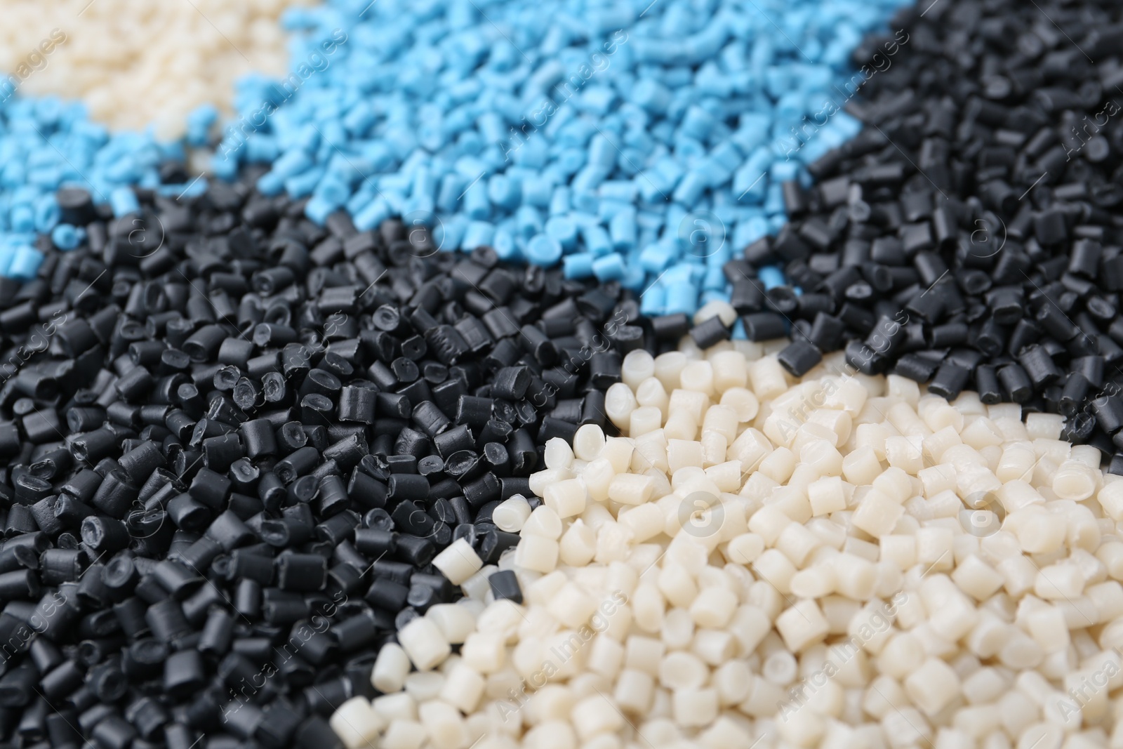 Photo of Pile of colorful plastic granules as background, closeup