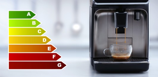 Image of Energy efficiency rating of home appliances. Electric espresso machine making coffee on white countertop in kitchen, banner design