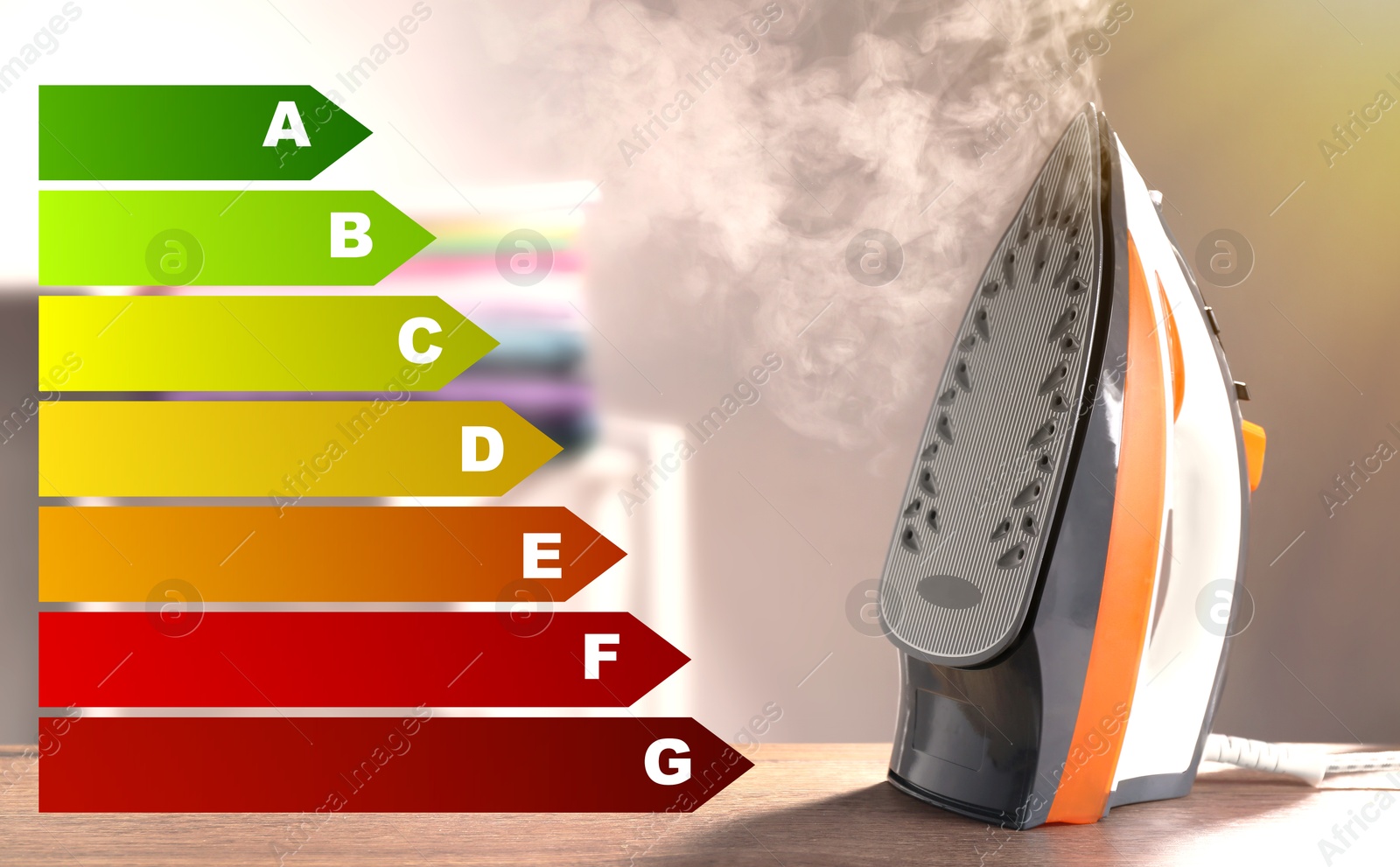 Image of Energy efficiency rating of home appliances. Iron with steam on table indoors