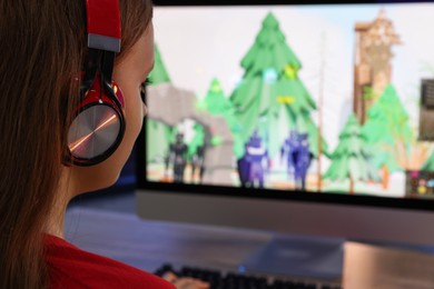 Girl watching game live stream at table, closeup