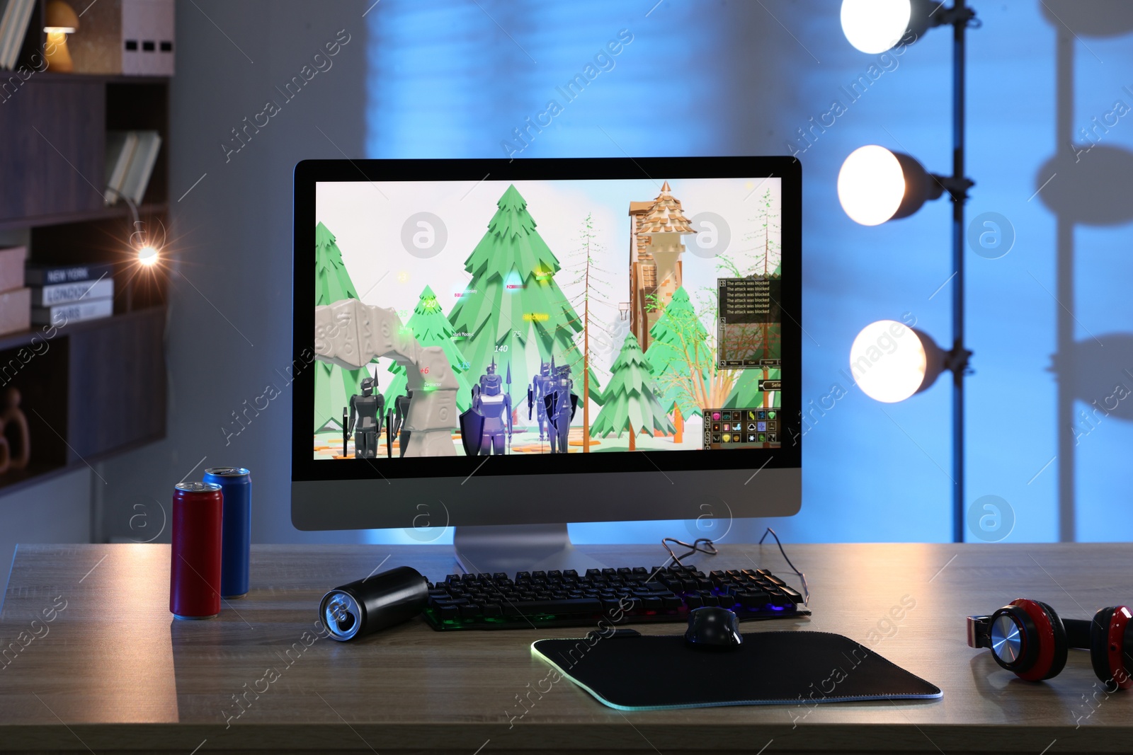 Photo of Computer keyboard, monitor, cans, headphones and mouse on table indoors