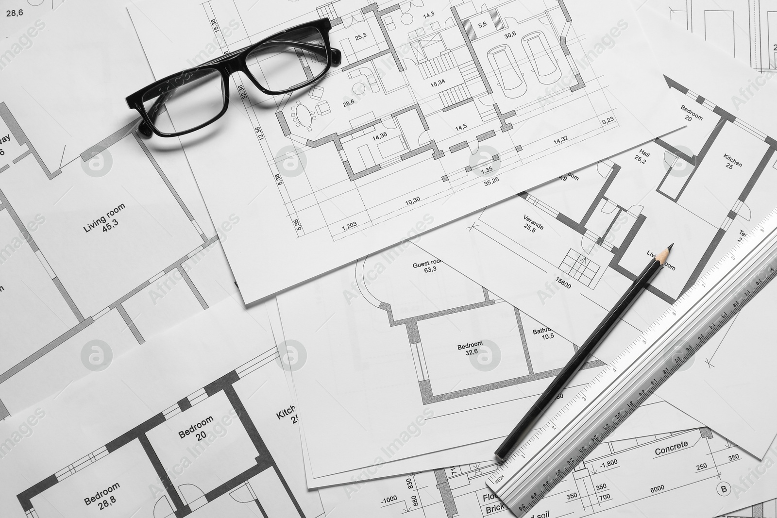 Photo of Different architectural drawings, glasses, ruler and pencil, top view