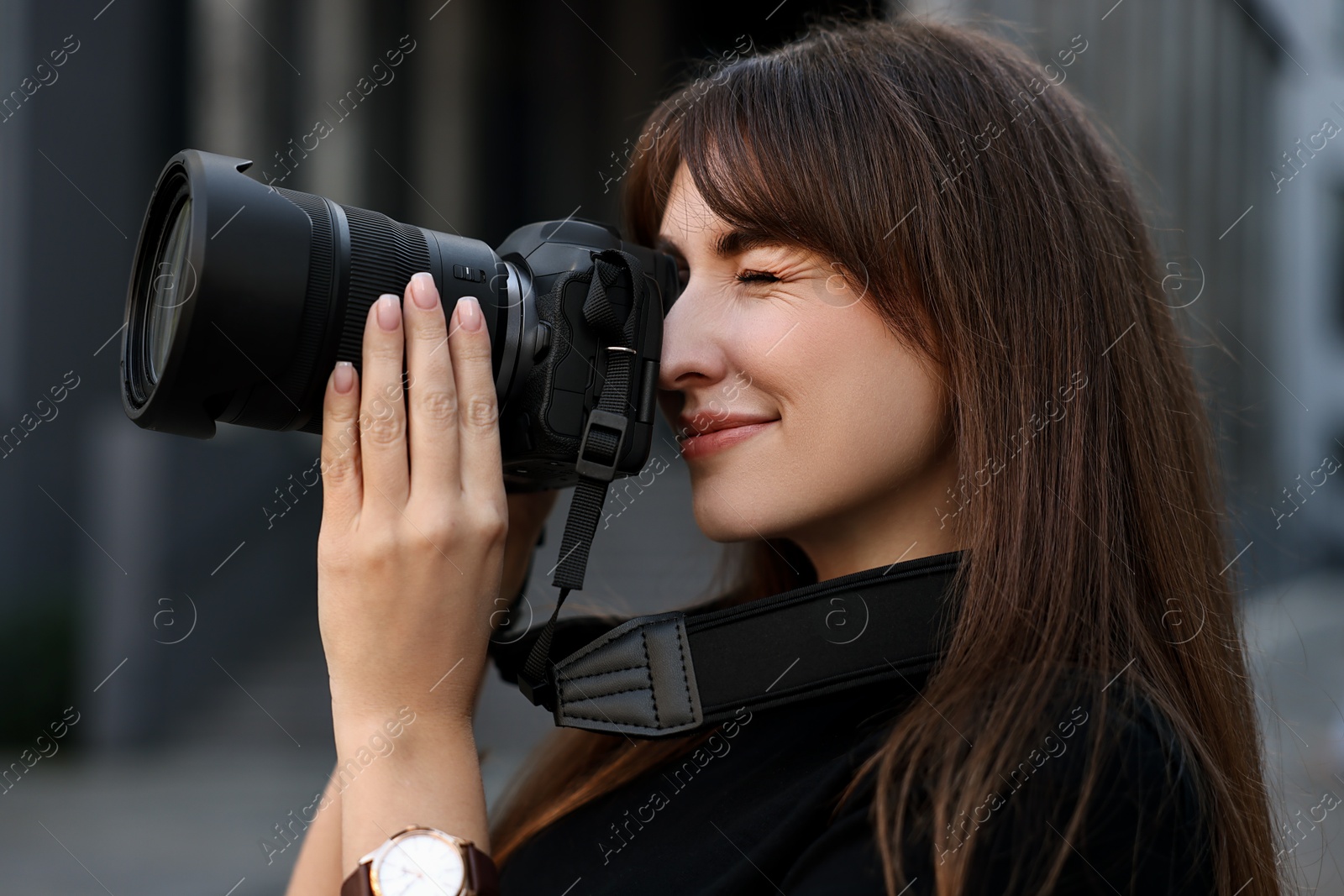 Photo of Professional photographer taking picture with camera outdoors