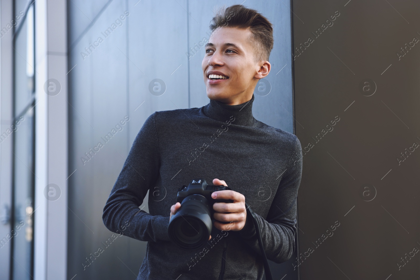 Photo of Professional photographer with camera near building outdoors