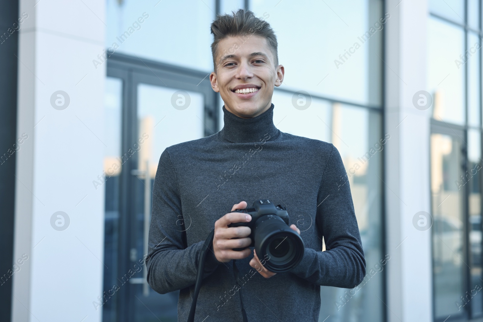 Photo of Professional photographer with camera near building outdoors