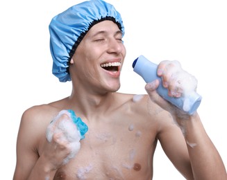 Photo of Man with shower cap, mesh sponge and shampoo singing on white background