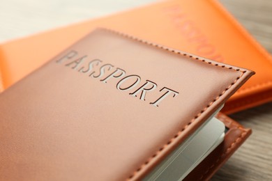 Photo of Passports in color covers on table, closeup