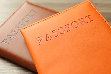 Photo of Passports in color covers on table, closeup