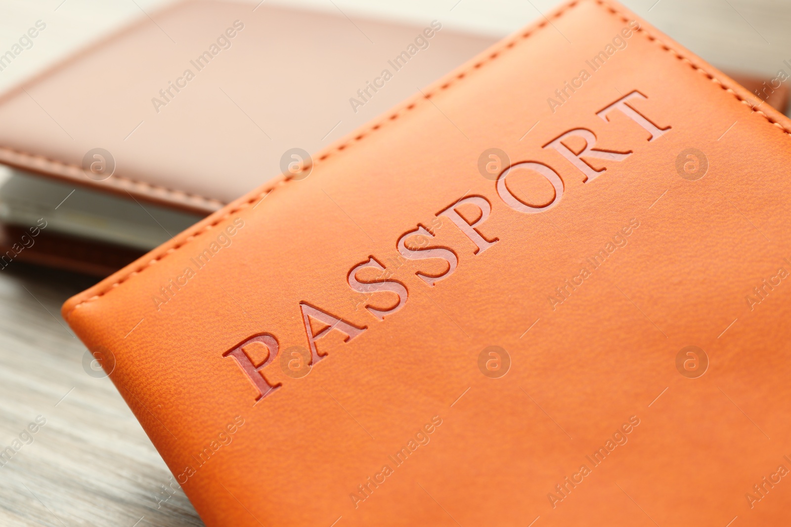 Photo of Passports in color covers on table, closeup