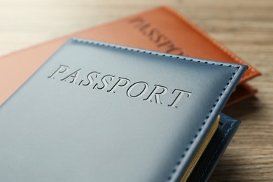 Photo of Passports in color covers on table, closeup