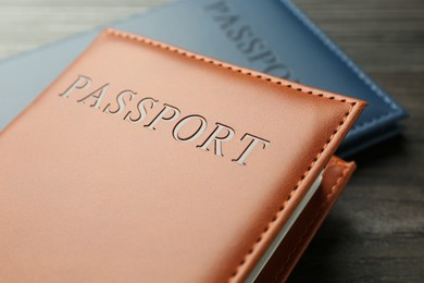 Photo of Passports in color covers on table, closeup