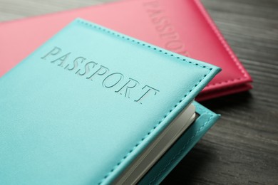 Photo of Passports in color covers on table, closeup