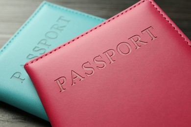 Photo of Passports in color covers on table, closeup