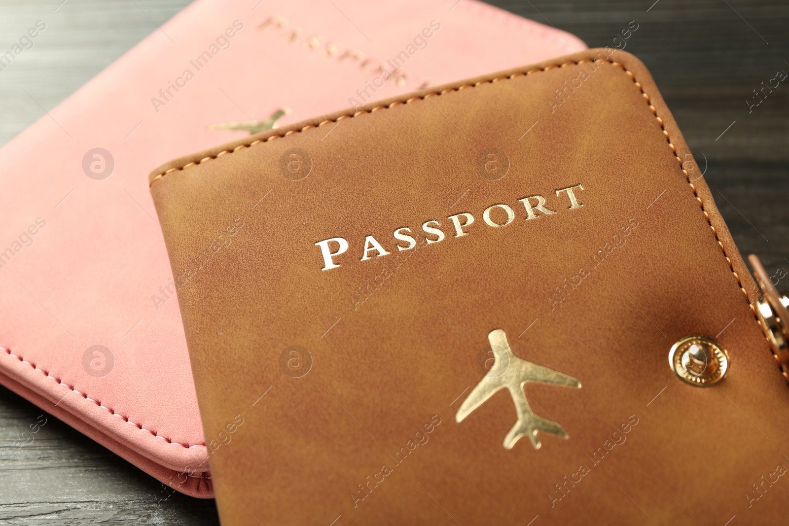 Photo of Passports in color covers on table, closeup