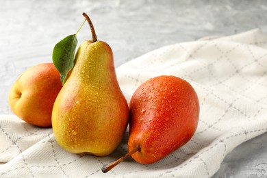 Photo of Ripe juicy pears on grey table, closeup