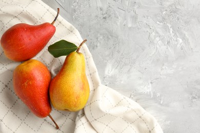 Photo of Ripe juicy pears on grey table, flat lay. Space for text