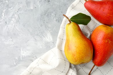 Photo of Ripe juicy pears on grey table, flat lay. Space for text