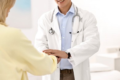 Photo of Healthcare worker supporting patient in hospital, closeup