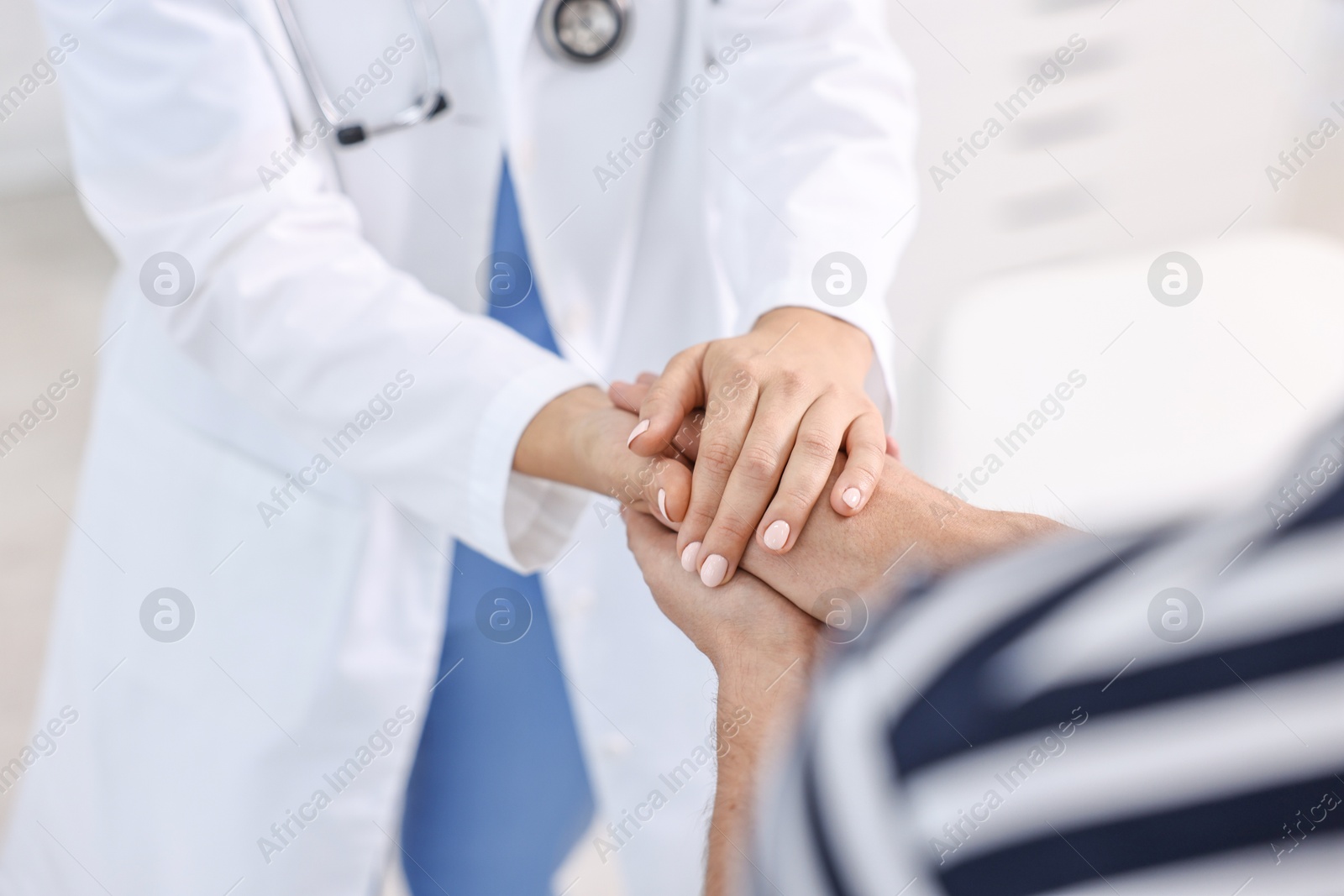 Photo of Healthcare worker supporting patient in hospital, closeup