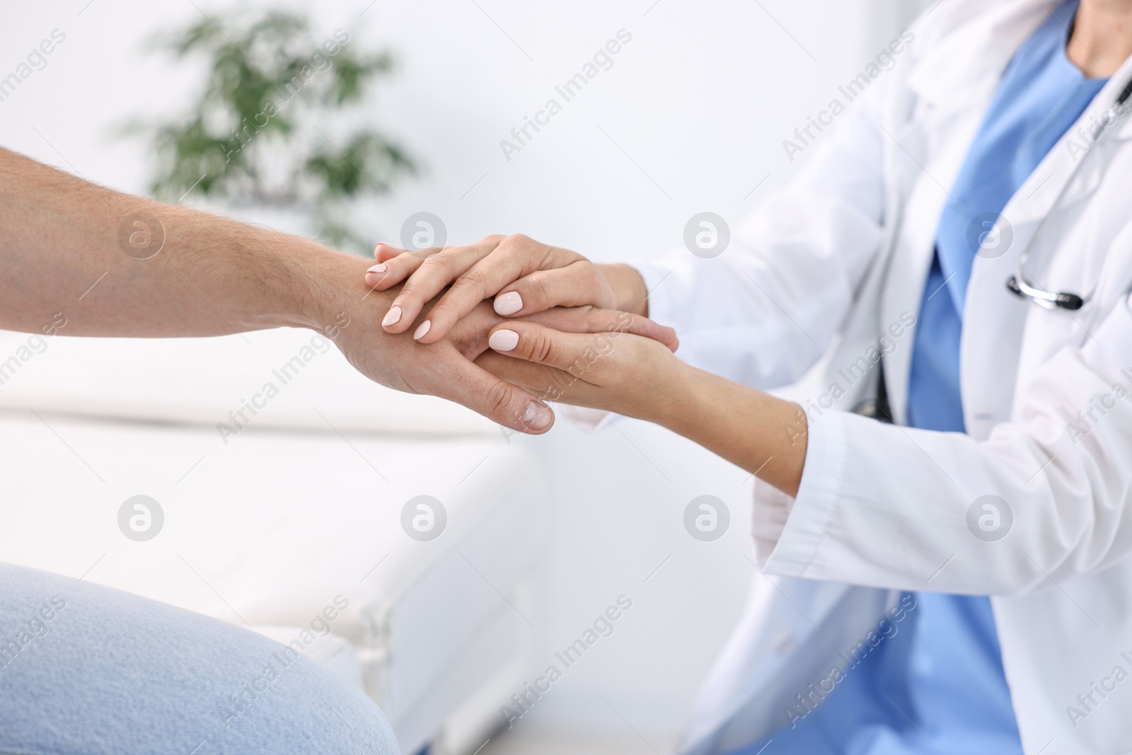 Photo of Healthcare worker supporting patient in hospital, closeup