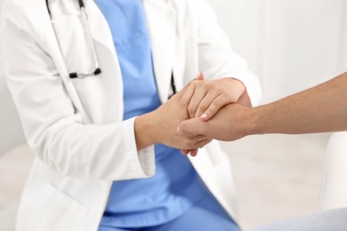 Photo of Healthcare worker supporting patient in hospital, closeup