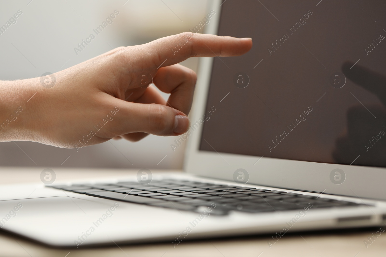 Photo of Businessman using laptop at table, closeup. Modern technology